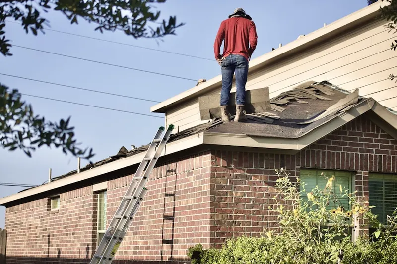 Professional roofer working on a residential roof in Downtown Medford